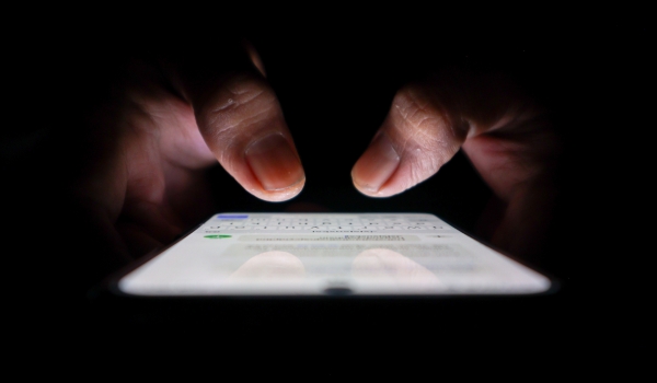 Night, cybersecurity and hands typing with phone for texting, internet troll or person cyberbullying